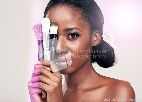 Image of Beauty, makeup brushes and portrait of black woman with cosmetics on face in studio with application tools. Skincare, brush and cosmetic skin care model with luxury contour tool on white background.