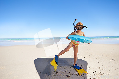 Image of Beach, girl child and swimming inflatable, snorkel and excited for fun against ocean background. Adventure, portrait and kid at the sea with a swim ring for exploring, playing and vacation in Bali
