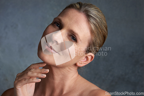 Image of Portrait, beauty and woman with cosmetics, dermatology and salon treatment against a studio background. Face, mature female and person with morning routine, grooming and smooth skin with skincare