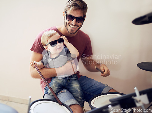 Image of Cool father, baby sunglasses and drummer musician with music development and child learning. Home, happiness and dad with youth drumming lesson with smile, love and parent care at a family house