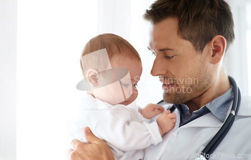 Image of Man, pediatrician and holding baby for healthcare assessment, wellness consulting and service for children. Kids, medical doctor and newborn in clinic, hospital and expert consultation for pediatrics