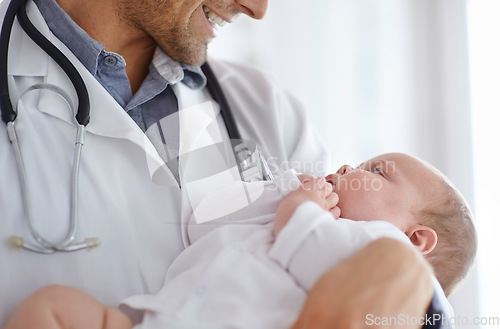 Image of Doctor, pediatrician and holding baby in arms for hospital assessment, medical support and growth. Pediatrics, happy physician and carrying newborn kid in clinic, healthcare service and help children