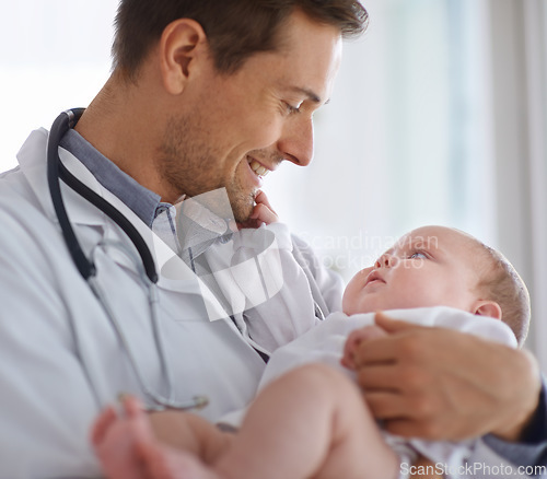 Image of Happy male doctor, pediatrician and holding baby for hospital assessment, medical support and growth. Pediatrics, physician and carrying newborn kid in clinic, healthcare service and helping children