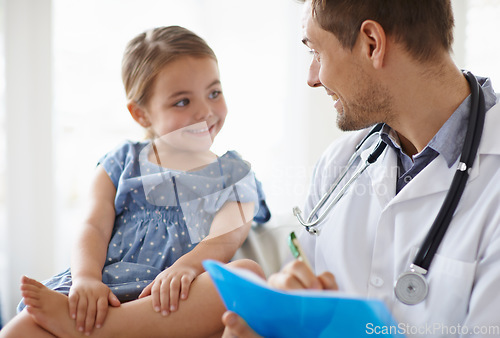 Image of Happy, child and pediatrician writing in clinic for healthcare consulting, wellness consultation and checkup. Medical doctor, girl kid and notes of assessment report, analysis and results in hospital