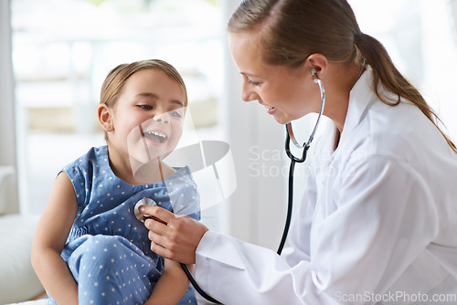 Image of Child, happy pediatrician and stethoscope for healthcare consulting, check lungs and listening to heartbeat. Woman, medical doctor and girl kid in clinic for chest assessment, analysis and checkup