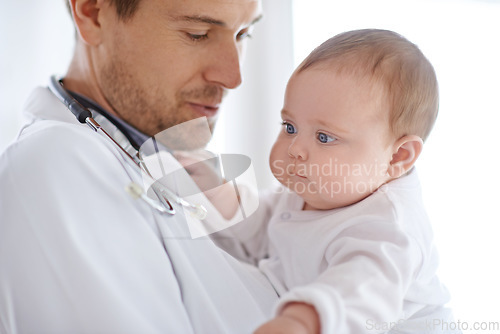 Image of Doctor, pediatrician and holding baby for healthcare assessment, medical support and growth. Newborn kids, man and pediatrics service in clinic, hospital or expert consulting for wellness of children