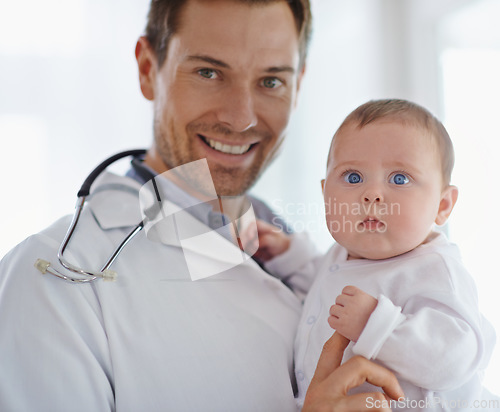 Image of Portrait, happy pediatrician and holding baby in hospital for medical support and growth. Newborn kid face, man and pediatrics doctor in clinic, healthcare service or smile of trust for children