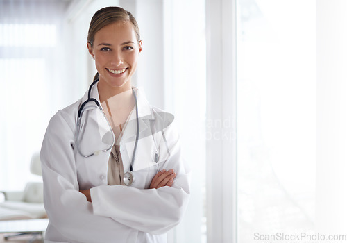 Image of Portrait of happy woman, arms crossed and doctor in hospital for healthcare, wellness and clinic services. Female medical employee, professional therapist and smile for trust, integrity and mockup