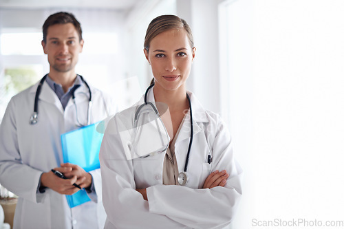 Image of Portrait of woman, arms crossed and team of doctors in hospital for healthcare, management and clinic services. Medical employees, surgery manager and collaboration for support, trust and checkup