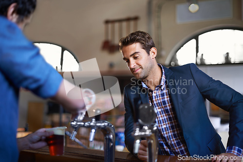 Image of Professional man at pub, order beer and relax on a break, leaning against countertop in bistro with alcohol drink. Hospitality industry, male business person at restaurant and enjoying social time