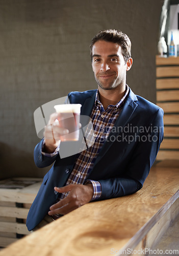 Image of Professional man at pub, happy with beer in portrait and cheers, relax and leaning against countertop in bistro. Hospitality industry, male business person at restaurant with alcohol drink and smile