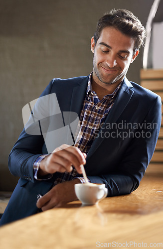 Image of Professional man at cafe, happy with coffee and relax on a break and leaning against countertop. Hospitality industry, male business person at restaurant with smile on face and stirring drink