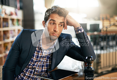 Image of Tired, stress and professional man with a tablet in the office while working on a corporate project. Technology, burnout and business male employee with a digital mobile for a report in the workplace