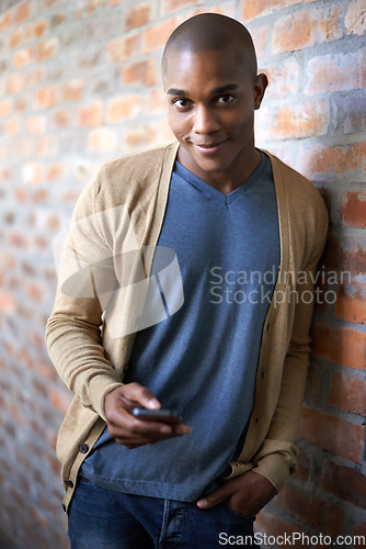 Image of School, phone and portrait of black man at brick wall for social media, technology or internet. Education, learning and scholarship with student at university for connection, contact or text message