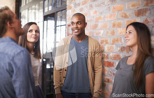 Image of Talking, friends or students in a college hallway for discussion, happiness and a chat. Group of diversity men and women at campus or university for conversation about education career or school work