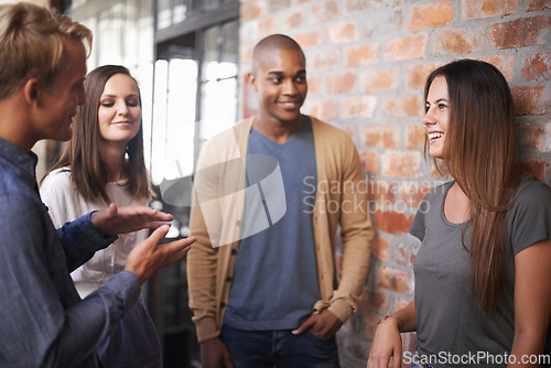 Image of Laughing, friends or students talking in a college hallway for discussion, funny chat and project. Group of diversity men and women at campus or university for a conversation about education career