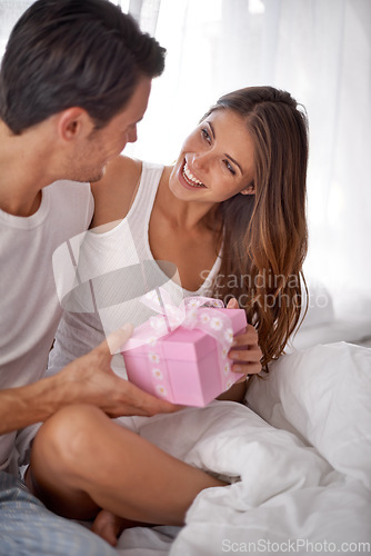 Image of Man giving woman gift, love and happy with partnership, relationship and celebration on Valentines day date. Couple smile with present, luxury and commitment, gratitude and celebrate holiday