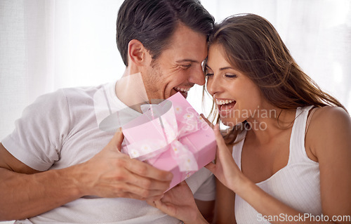 Image of Man giving woman gift, love and happiness with partnership, relationship and celebration on Valentines day date. Couple laugh with present, luxury and commitment, gratitude and celebrate holiday