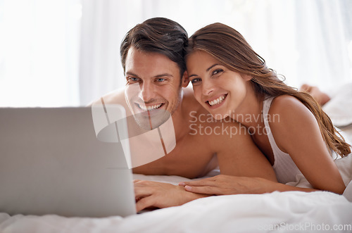 Image of Love portrait, laptop and bedroom couple relax for morning peace, calm and streaming online Valentines Day movie. Smile, vacation holiday and romantic people bonding on hotel bed in Toronto Canada