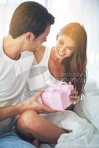 Image of Man giving woman gift box, love and happy with partnership, relationship and celebration on Valentines day date. Couple smile with present, luxury and commitment, gratitude and celebrate holiday