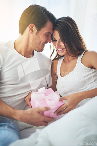 Image of Man giving woman gift, love and happy with partnership, relationship and celebration on Valentines day date. Couple smile with present, luxury and commitment, gratitude and celebrate holiday