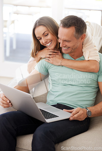 Image of Computer, hug and happy couple on sofa for internet, online reading and website review, together planning for home or marriage. Affection, love and relaxing mature partner, woman or people on laptop