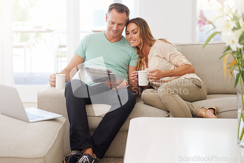 Image of Reading, newspaper and mature couple on couch with tea, love and affection and relax together for holiday or news. Happy partner, woman or people on sofa with morning paper in lounge and coffee