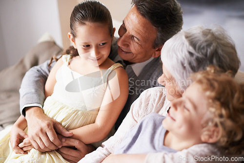 Image of Smile, love or happy grandparents with children hug to embrace care together in family home in retirement. Elderly grandma, old man or kids siblings relaxing or bonding to enjoy quality time together