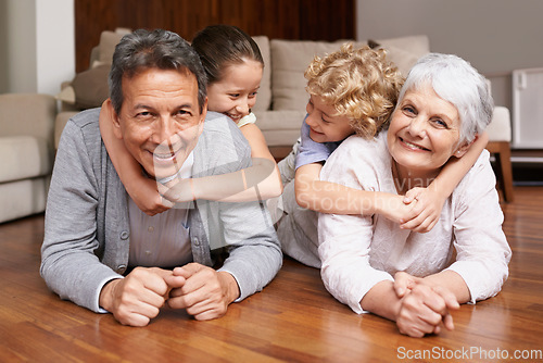 Image of Floor, piggyback or portrait of grandparents with happy kids playing or hugging with love in family home. Elderly grandma or fun old man relaxing or bonding to enjoy time with children in retirement