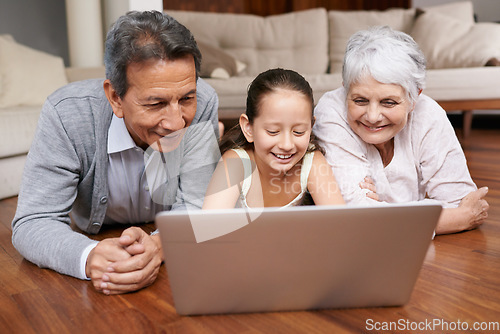 Image of Laptop, floor or grandparents with girl for movie streaming online subscription in retirement at home together. Child, relaxing or happy grandmother loves watching fun videos with a senior old man