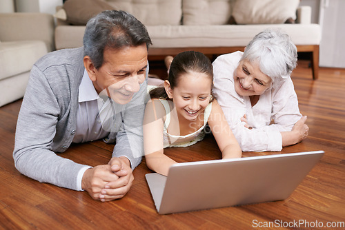 Image of Laptop, floor or grandparents with happy girl for movie streaming online subscription in retirement at home. Child, relaxing together or grandmother watching funny comedy videos with a senior old man