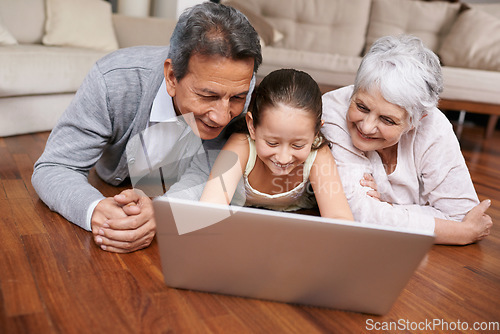 Image of Laptop, floor or grandparents with happy child for movie streaming online subscription in retirement at home. Girl, relaxing together or grandmother watching videos on internet with a senior old man