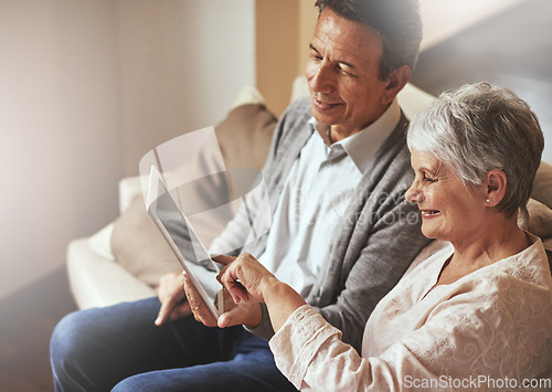 Image of Tablet, relax or old couple streaming film or movies on online subscription in retirement at home together. Love, pointing or senior woman watching videos with a happy elderly man in living room sofa