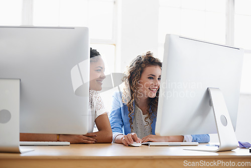 Image of Women, computer or happy people in office talking, chatting or speaking of gossip or online news together. Internet, smile or friends in conversation or discussion about on blog or article at desk