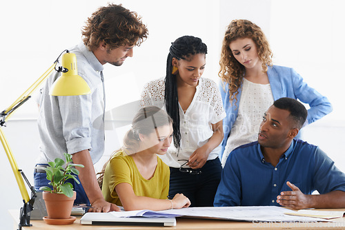 Image of Business people, blueprint and meeting in teamwork construction, planning or collaboration at the office. Architect group working on paperwork for architecture project or floor plan at the workplace