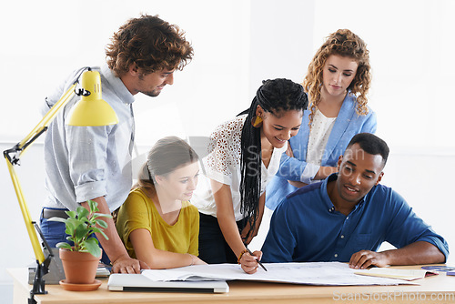 Image of Diversity, business people and writing on blueprint in meeting for brainstorming, planning or ideas at office. Architect group working on document, floor plan or strategy in construction at workplace