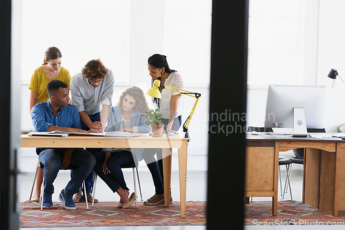 Image of Diversity, business people and documents in team collaboration for project planning or strategy at the office. Group of employees in meeting working on paperwork together for plan at the workplace