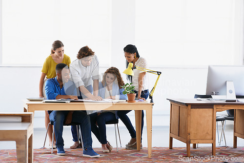 Image of Diversity, business people and documents in project planning, team collaboration or strategy at the office. Group of employees in meeting working on paperwork in teamwork for plan at the workplace