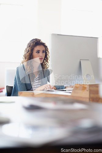 Image of Journalist, office or woman with computer to research news, online business or digital project. Focus, database or serious girl employee writing blog reports or internet article on pc or laptop desk