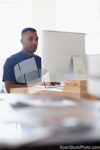 Image of Journalist, office or black man with computer to research news, online business or digital project. Focus, database or serious employee writing blog reports or internet article on pc or laptop desk