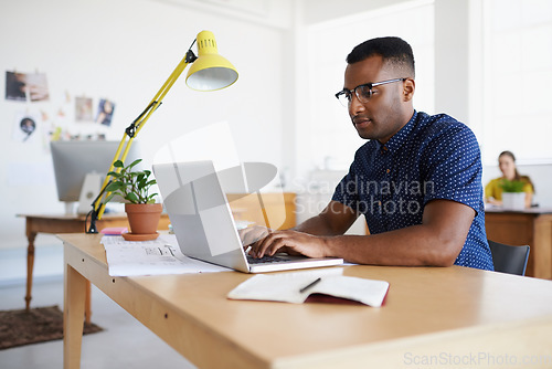 Image of Journalist, serious or black man typing on laptop working on email, business project or online research. Computer, digital agency or focused worker copywriting on blog, reports or internet article