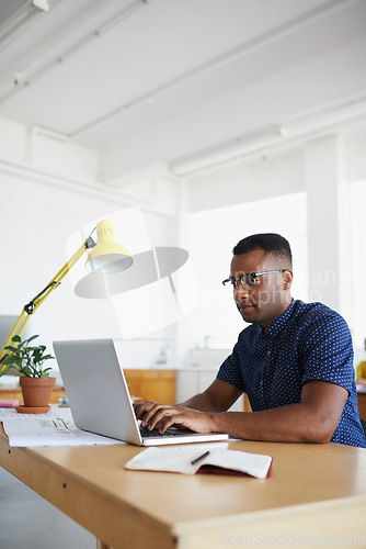 Image of Journalist, office or black man copywriting on laptop working on business project or online research. Computer, digital agency or focused worker typing for blog content, reports or internet article