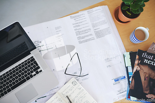 Image of Notebook, laptop and blueprint on office desk above for architecture planning, strategy or layout. Top view of building paperwork, floor plan or architect notes for construction ideas on workspace