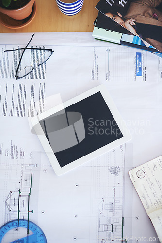 Image of Tablet, blueprint and mockup on office desk above for architecture planning, strategy or layout. Top view of building paperwork, floor plan or architect notes in construction with tech screen display