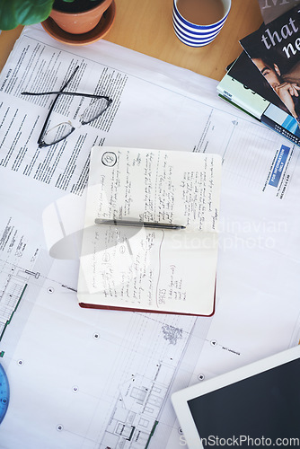 Image of Notebook, blueprint and writing on office desk above for architecture planning, strategy or layout. Top view of building paperwork, floor plan or architect notes for construction, ideas or design