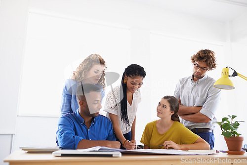 Image of Diversity, business people and writing in team project, planning or strategy together at office. Group of diverse employees working on paperwork, documents or teamwork for brainstorming at workplace