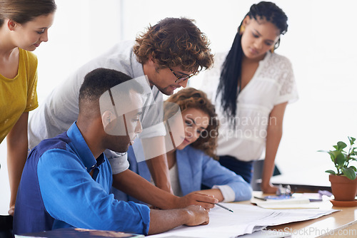 Image of Businessman, coaching and writing on documents for planning, strategy or brainstorming at the office. Business people listening to coach ideas in teamwork for group project plan or training staff