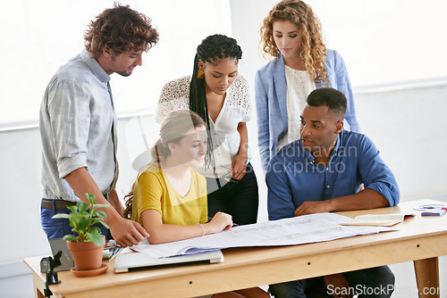 Image of Creative business people, blueprint and planning in meeting for architecture or construction on office desk. Architect group in project discussion with floor plan in team collaboration for startup