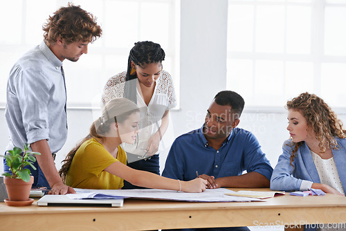 Image of Business people, blueprint and sharing ideas in meeting for construction planning or architecture at the office. Architect group working together on document, project or floor plan at the workplace