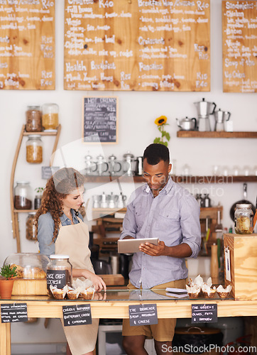 Image of Small business, talking and employees with a tablet, digital planning or share ideas for profit growth. Black man, woman or coworkers with technology, store or happiness with communication at a store